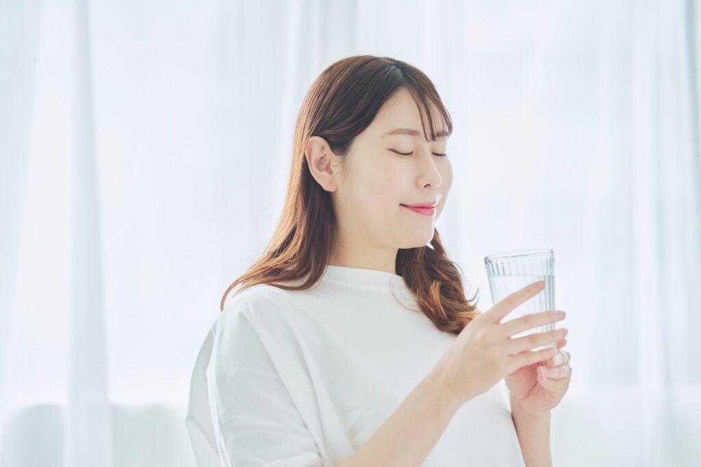 目を瞑ってグラスを持つ女性